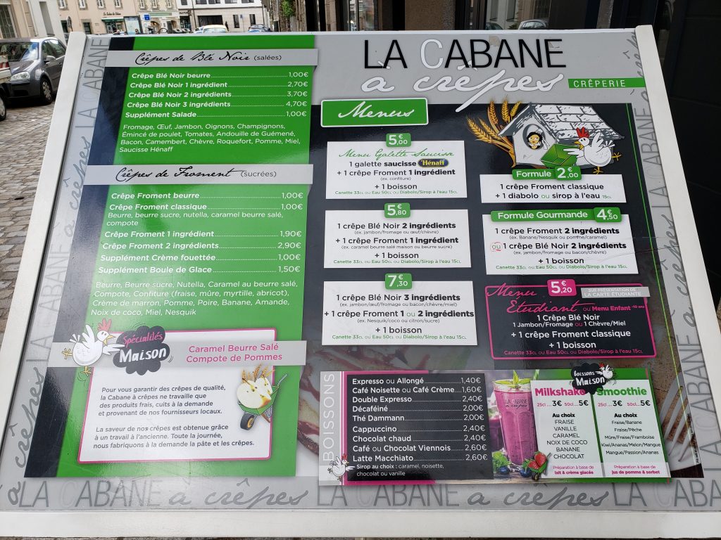 Full menu board outside the LA CABANE à crêpes restaurant in Quimper, France 
