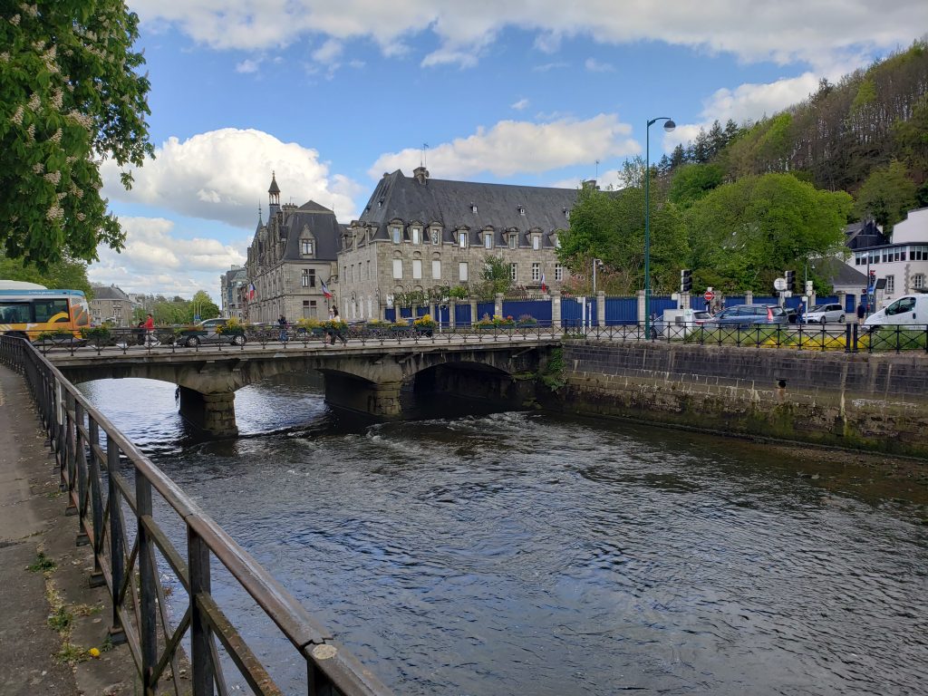 The Odet River in Quimper, France rolling under a bridge and through the center of town