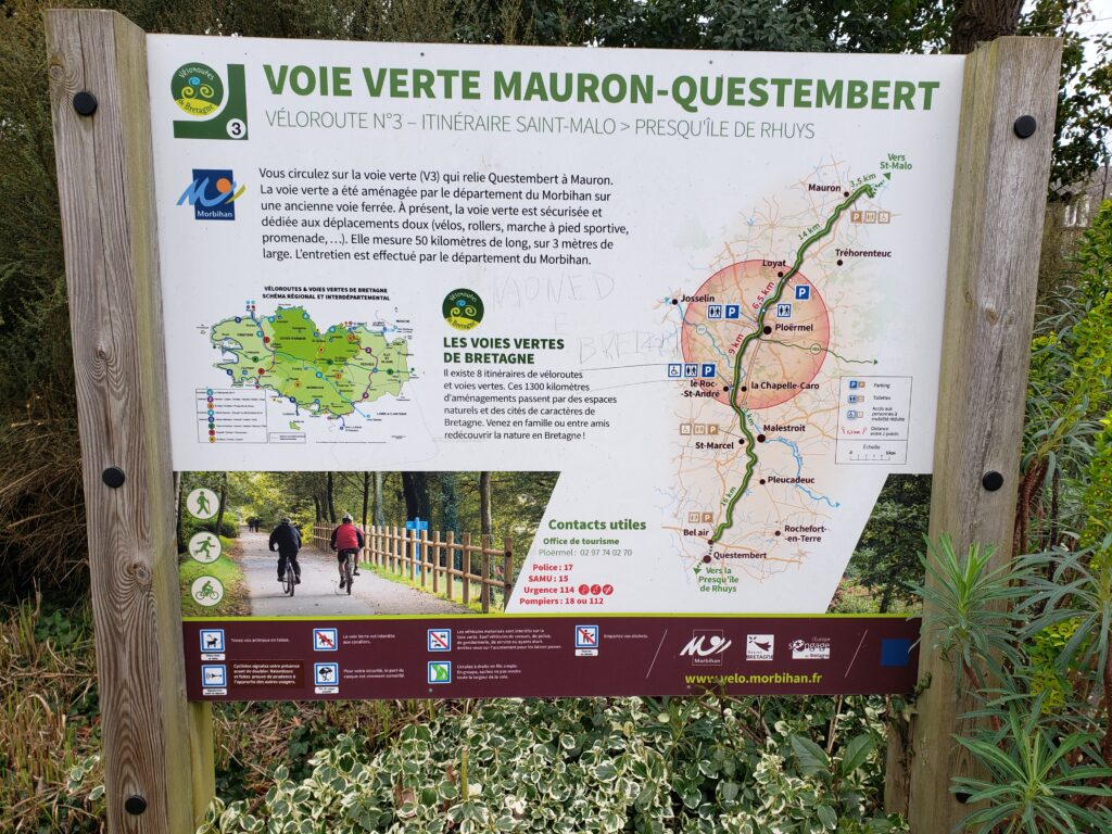Bike route outdoor signage with map of Veloroute Number 3 showing path through Ploërmel, France and to the north and south